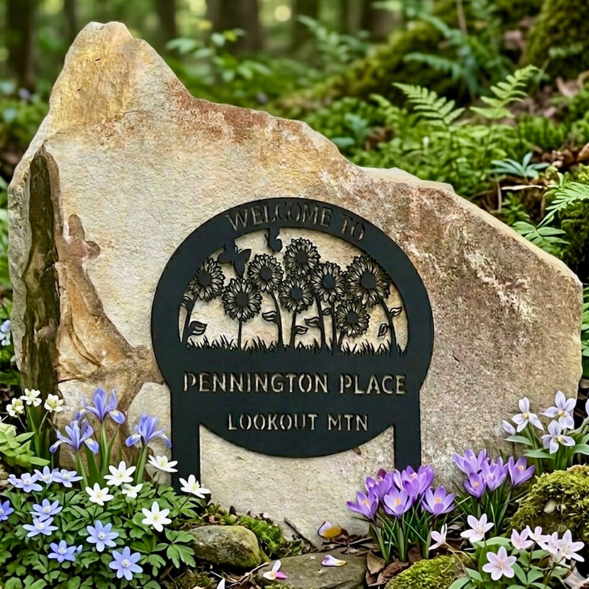 Welcome to Pennington Place sign among spring wildflowers