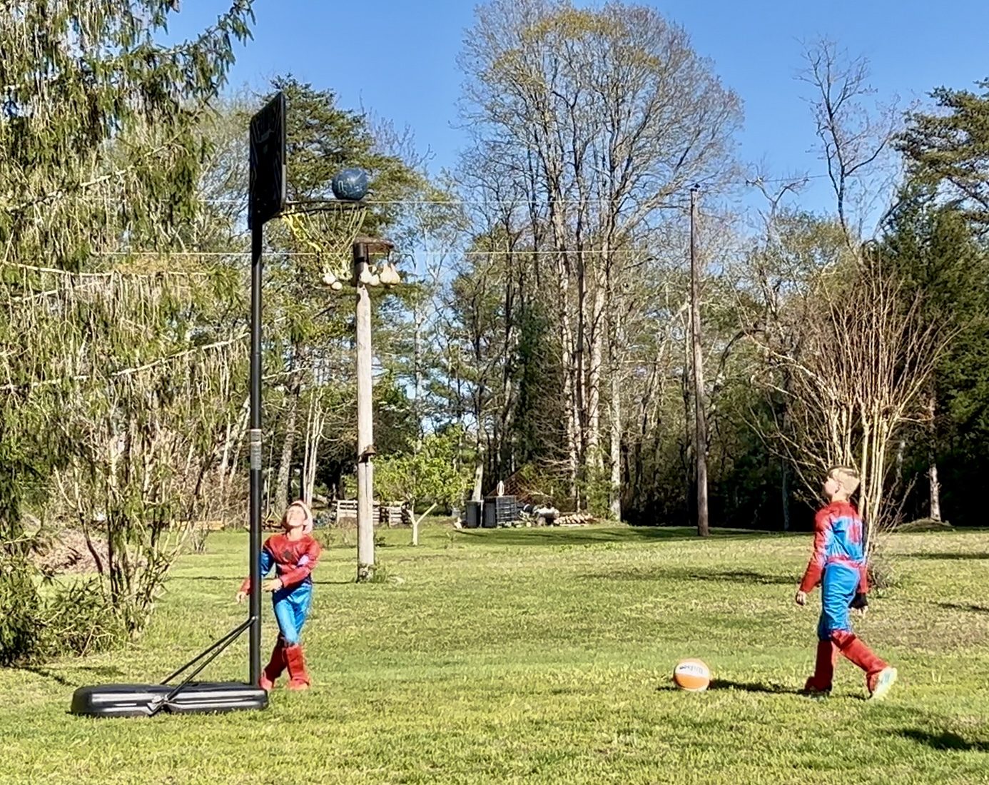 Superheroes shooting hoops in the play yard