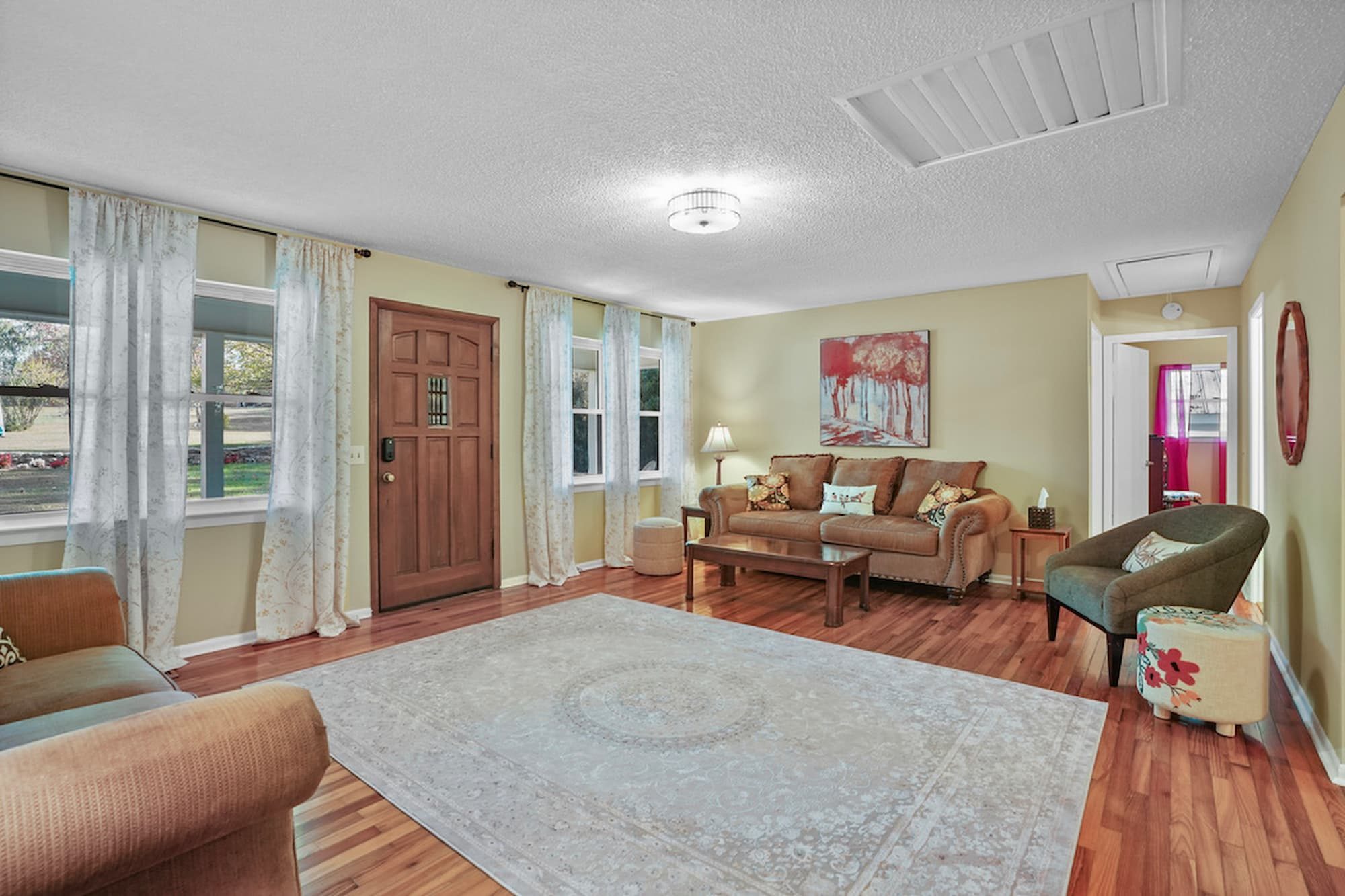 Bright living room with hardwood floors and comfortable seating